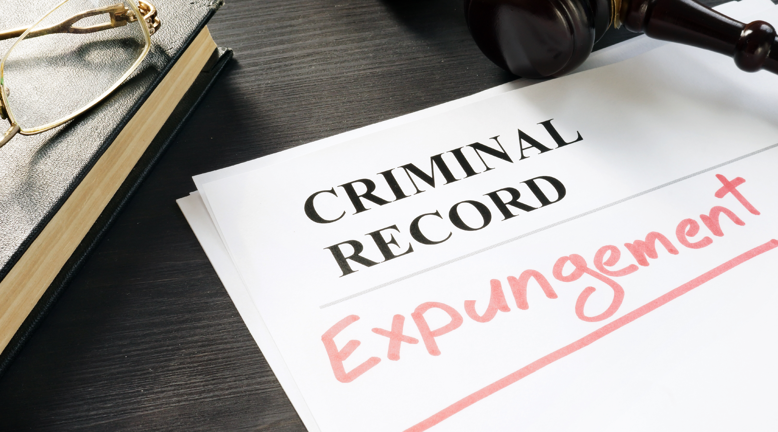 Photo of a paper on a black desk that says "Criminal Record Expunged", answering the question, can a DWI conviction be expunged in Minnesota?